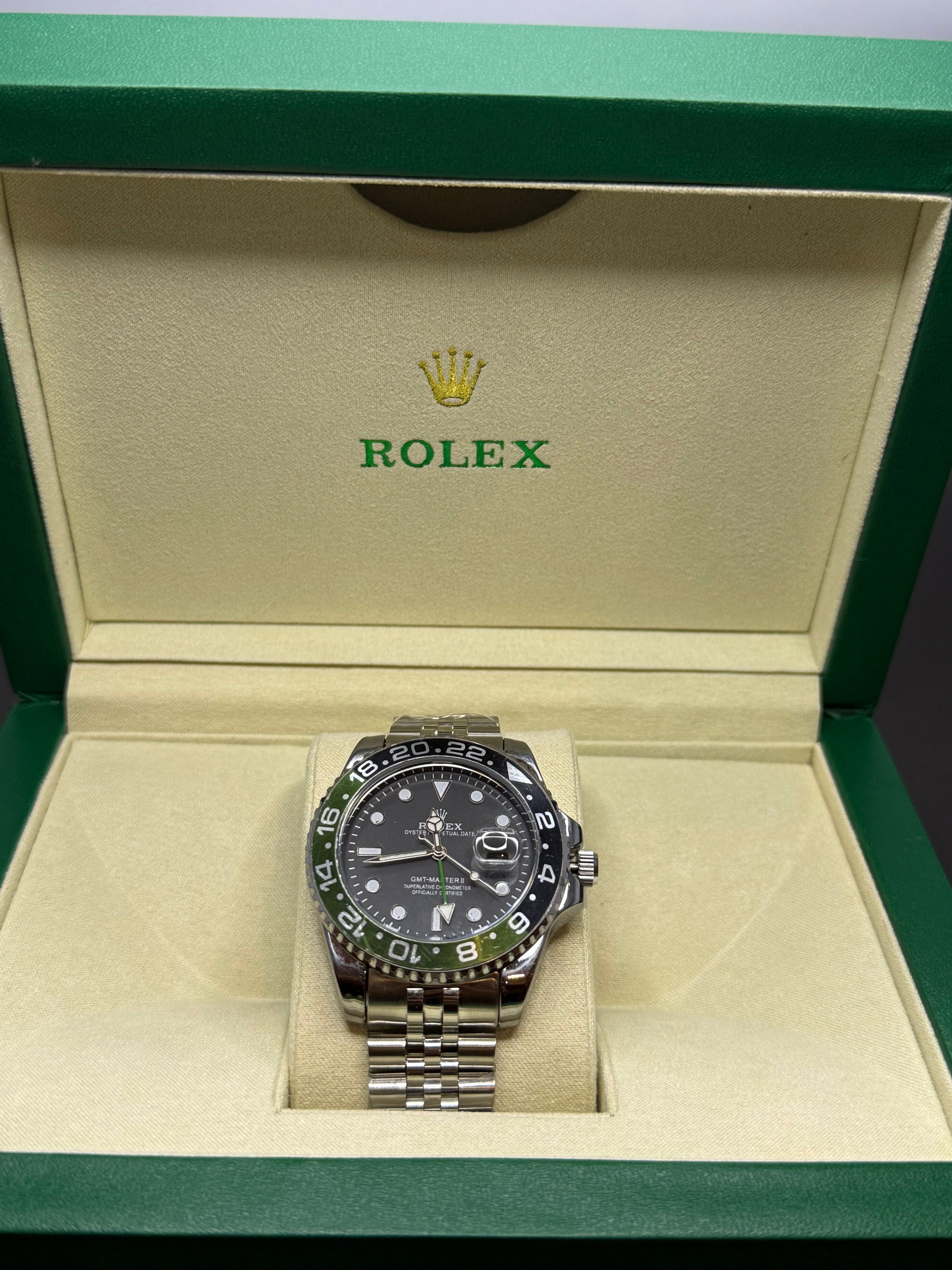 Rolex silver case watch black dial green accents luxury Pakistan